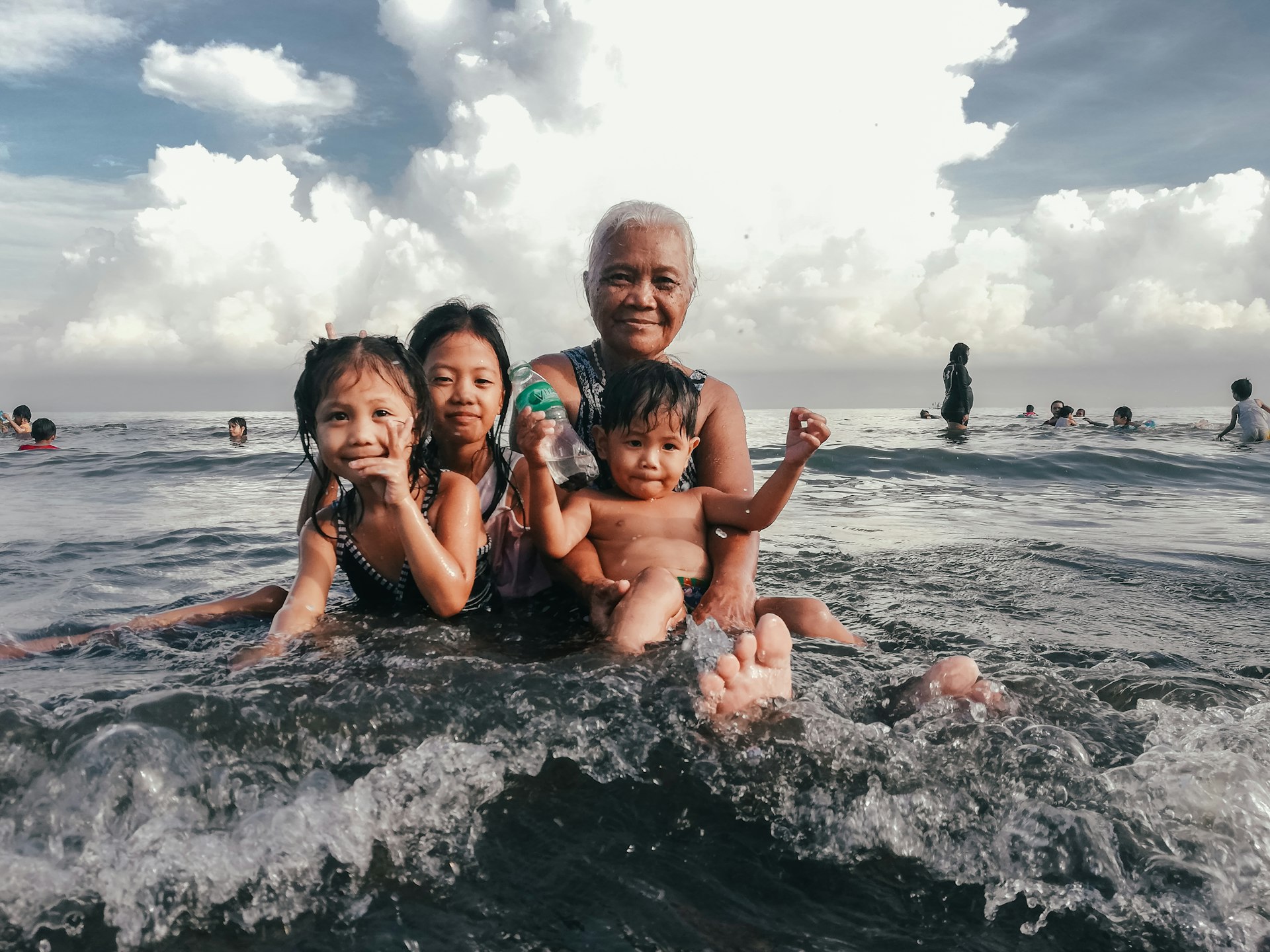 three children and man at the beach