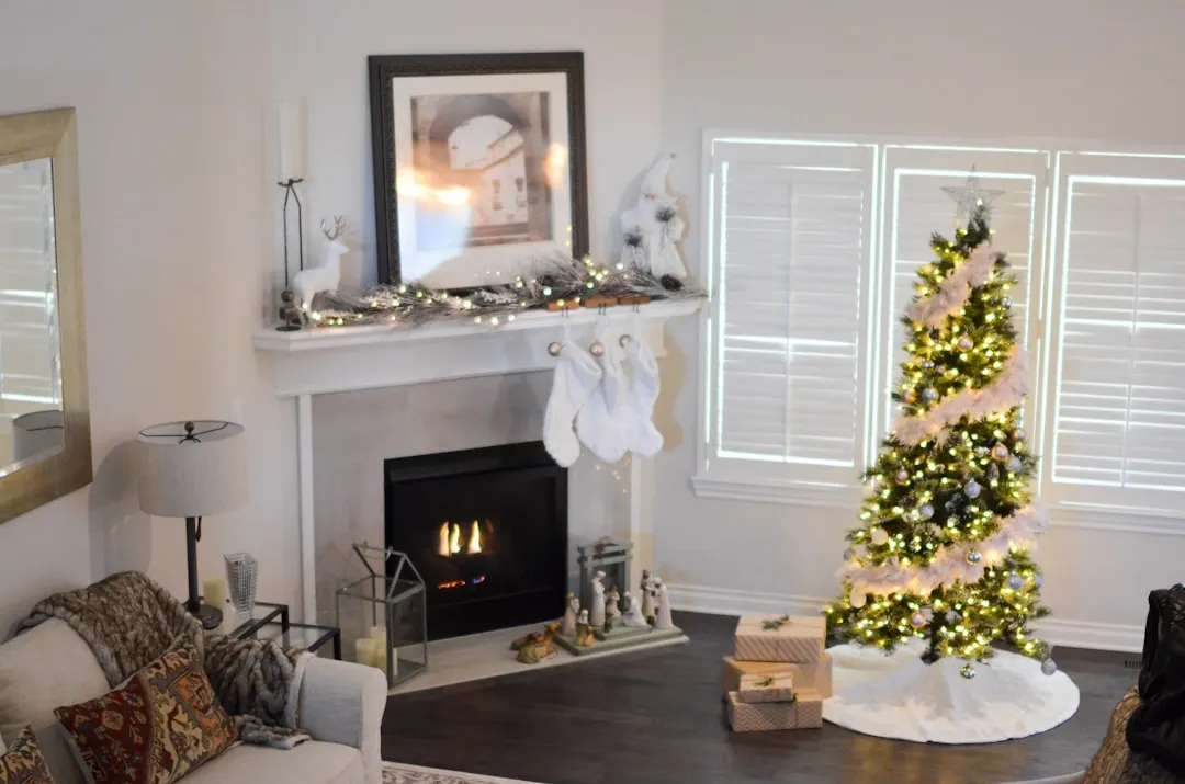 Christmas tree, fireplace and a clean winter living room